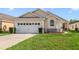 Charming single-story home with a well-manicured lawn and attached two-car garage at 4533 Oakbrook Ct, Kissimmee, FL 34746