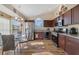 Eat-in kitchen features stainless appliances, wood cabinets, and a sunny breakfast nook at 4533 Oakbrook Ct, Kissimmee, FL 34746