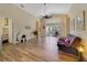 Spacious living room with wood-look flooring, ceiling fan, and sliding glass doors at 4533 Oakbrook Ct, Kissimmee, FL 34746