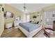 Bright main bedroom features wood floors, a ceiling fan, mirrored wall, and a TV at 4533 Oakbrook Ct, Kissimmee, FL 34746
