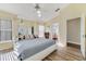 Light-filled main bedroom with wood floors, a ceiling fan, and an ensuite bathroom at 4533 Oakbrook Ct, Kissimmee, FL 34746
