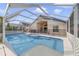 Backyard pool and spa area, perfect for entertaining, with screened-in lanai and outdoor seating at 4533 Oakbrook Ct, Kissimmee, FL 34746