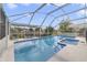Inviting screened-in pool and jacuzzi area with outdoor seating, perfect for enjoying sunny days at 4533 Oakbrook Ct, Kissimmee, FL 34746