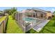 Screened-in backyard featuring a pool, jacuzzi, and outdoor seating area for relaxation and entertainment at 4533 Oakbrook Ct, Kissimmee, FL 34746