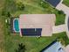 An overhead perspective of a single-Gathering home with a pool and solar panels at 456 Old Bridge Cir, Davenport, FL 33897