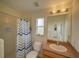 The bright bathroom features a shower and tub combination and neutral tones at 456 Old Bridge Cir, Davenport, FL 33897