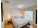 Cozy bedroom with a queen bed, side tables, and natural light from the window at 456 Old Bridge Cir, Davenport, FL 33897