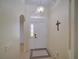 Welcoming foyer with decorative lighting, arched doorway, and tile flooring, creating an elegant entrance at 456 Old Bridge Cir, Davenport, FL 33897