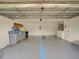 Spacious garage with painted floor and ample storage space, perfect for projects and organization at 456 Old Bridge Cir, Davenport, FL 33897