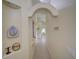 Bright hallway featuring arched entryways, neutral walls, and tile flooring, providing a seamless flow throughout the home at 456 Old Bridge Cir, Davenport, FL 33897