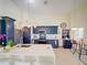Open concept kitchen with large island, navy cabinets, and pendant lighting at 456 Old Bridge Cir, Davenport, FL 33897