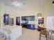 Bright kitchen features a large island, navy cabinets, stainless steel appliances, and adjacent breakfast nook at 456 Old Bridge Cir, Davenport, FL 33897