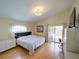 Light and bright bedroom featuring access to the pool and patio area at 456 Old Bridge Cir, Davenport, FL 33897