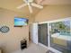 Relax on the patio, featuring a TV and sliding glass doors with views of the pool at 456 Old Bridge Cir, Davenport, FL 33897