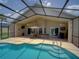 Sparkling pool with covered lanai, ceiling fans, and bar area provide a relaxing outdoor retreat at 456 Old Bridge Cir, Davenport, FL 33897