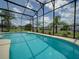 Sparkling pool featuring a screened enclosure with backyard views at 456 Old Bridge Cir, Davenport, FL 33897