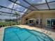 Private screened-in pool area with ample seating and a well-maintained deck at 456 Old Bridge Cir, Davenport, FL 33897