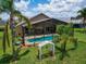 Enjoy outdoor living in this beautiful backyard with a screened-in pool and lush landscaping at 456 Old Bridge Cir, Davenport, FL 33897