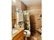 Accessible bathroom with tile, a seated shower, and a vanity with storage at 46 Carriage Hill Cir, Casselberry, FL 32707