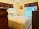 Bedroom with plush bedding, neutral decor, and a window for natural light at 46 Carriage Hill Cir, Casselberry, FL 32707