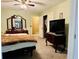 Bedroom showing a TV, dresser, a bed with a brown blanket, and a closet, all contributing to the room's comfort at 46 Carriage Hill Cir, Casselberry, FL 32707