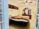 The bedroom has neutral walls, complemented by a dark wooden dresser set, and is naturally lit by a window at 46 Carriage Hill Cir, Casselberry, FL 32707