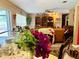 Dining room view showcasing vibrant floral arrangements, elegant tableware and a portion of the spacious living area at 46 Carriage Hill Cir, Casselberry, FL 32707