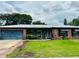 Charming single-story home with a well-maintained lawn, brick facade and attached garage at 46 Carriage Hill Cir, Casselberry, FL 32707