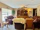 This inviting living room features a large window, a custom built-in bookshelf, and comfortable seating, creating a cozy ambiance at 46 Carriage Hill Cir, Casselberry, FL 32707