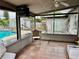 The patio has a tiled floor, and a screen enclosure for enjoying the outdoors, with a view of the backyard and pool at 46 Carriage Hill Cir, Casselberry, FL 32707