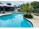 Backyard scene of a kidney shaped pool, framed by lush landscaping creating a serene and private oasis at 46 Carriage Hill Cir, Casselberry, FL 32707