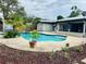 This kidney shaped pool is the centerpiece of the backyard, enhanced by landscaping and a well-maintained patio area at 46 Carriage Hill Cir, Casselberry, FL 32707