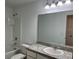 Bright bathroom with a vanity, a large mirror, and a shower-tub combination, designed for comfort and functionality at 477 Madison Dr, Davenport, FL 33837