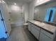 Well-lit bathroom with a tub-shower, a vanity with a granite countertop, and modern fixtures at 477 Madison Dr, Davenport, FL 33837