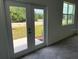 Bright living space with glass doors to the backyard, and a view of the lush greenery outside at 477 Madison Dr, Davenport, FL 33837