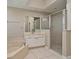 Bright bathroom featuring a glass-enclosed shower and a soaking tub with a tile surround at 492 Lanarkshire Pl, Apopka, FL 32712