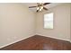 Cozy bedroom with hardwood floors, a ceiling fan, and a window providing natural light at 492 Lanarkshire Pl, Apopka, FL 32712