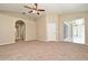 Expansive primary bedroom with an ensuite bathroom, fan, and sliding glass door at 492 Lanarkshire Pl, Apopka, FL 32712