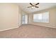 Spacious bedroom featuring carpet, ceiling fan and a large window with plenty of light at 492 Lanarkshire Pl, Apopka, FL 32712