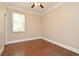 Simple bedroom with wood floors, neutral paint, and a large window at 492 Lanarkshire Pl, Apopka, FL 32712