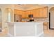 Modern kitchen features granite countertops, wooden cabinets, and stainless steel appliances at 492 Lanarkshire Pl, Apopka, FL 32712