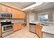 Modern kitchen featuring stainless steel appliances, granite countertops, and tile backsplash at 492 Lanarkshire Pl, Apopka, FL 32712