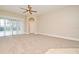 Bright and airy living room with plush carpet and sliding glass doors leading to the pool at 492 Lanarkshire Pl, Apopka, FL 32712