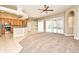 Open concept living area with a modern kitchen, tile floors, and a living room with carpet at 492 Lanarkshire Pl, Apopka, FL 32712
