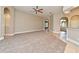 Open living room with plush carpet, modern lighting, and a connecting kitchen area at 492 Lanarkshire Pl, Apopka, FL 32712