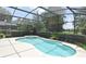 Screened-in pool with a spa and clear water, surrounded by lush greenery and providing a private retreat at 492 Lanarkshire Pl, Apopka, FL 32712