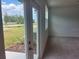 A bright living room with access to a back patio and a view of a backyard area at 497 Madison Dr, Davenport, FL 33837