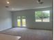 Open-concept living room featuring plush carpeting, recessed lighting, and an abundance of natural light at 497 Madison Dr, Davenport, FL 33837