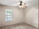 Bedroom with a ceiling fan, window, neutral walls, and plush carpeting at 507 Northlake Dr # 507, Sanford, FL 32773
