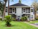 Inviting two-story condo featuring a well-manicured lawn and charming staircases leading to screened balconies at 507 Northlake Dr # 507, Sanford, FL 32773